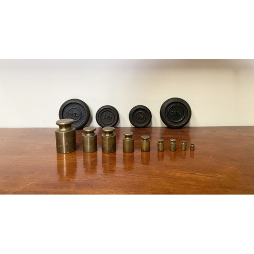 197 - A SET OF BRASS WEIGHTS ALONG WITH CAST IRON WEIGHTS.