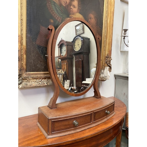 206 - A 19TH CENTURY MAHOGANY DRESSING TABLE MIRROR, oval mirror in scroll supports, atop bow fronted base... 