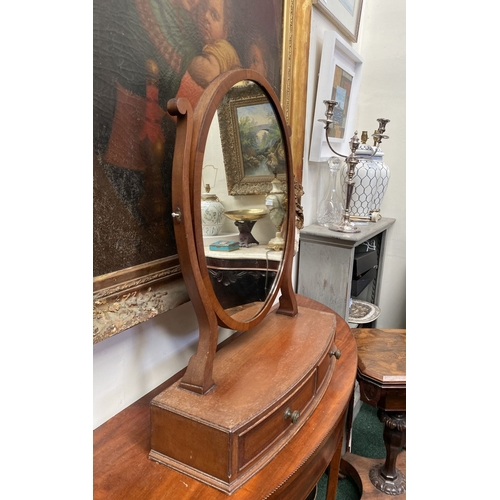 206 - A 19TH CENTURY MAHOGANY DRESSING TABLE MIRROR, oval mirror in scroll supports, atop bow fronted base... 