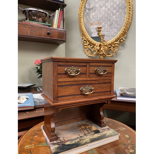 218 - A MAHOGANY APPRENTICE THREE DRAWER CHEST, with two short over one long drawer, each with brass handl... 