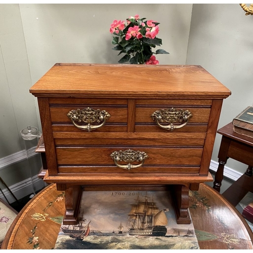 218 - A MAHOGANY APPRENTICE THREE DRAWER CHEST, with two short over one long drawer, each with brass handl... 
