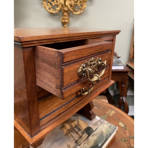 218 - A MAHOGANY APPRENTICE THREE DRAWER CHEST, with two short over one long drawer, each with brass handl... 