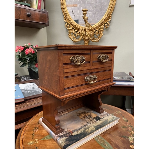 218 - A MAHOGANY APPRENTICE THREE DRAWER CHEST, with two short over one long drawer, each with brass handl... 