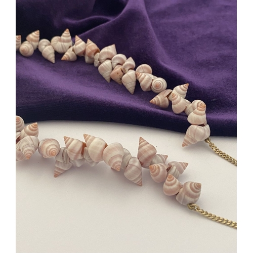 228 - A PRETTY SHELL BEADED NECKLACE ON 9CT GOLD CHAIN, hallmarked 375 to clasp. Shells in overall good co... 