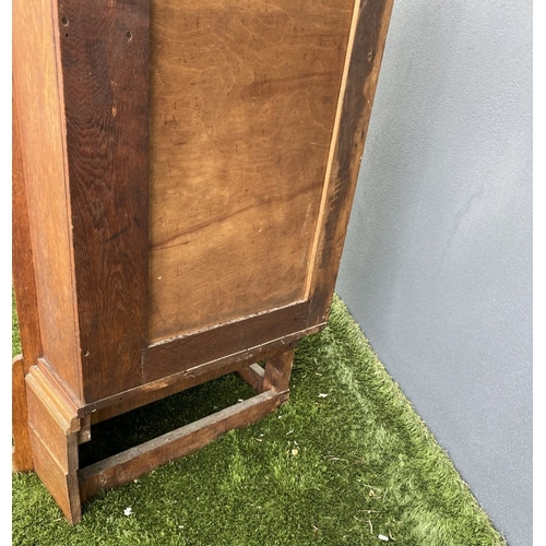 229 - AN ANTIQUE OAK CORNER DISPLAY CABINET, with glazed door revealing shelved interior above shaped base... 