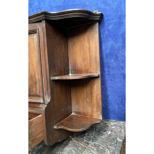 234 - AN ANTIQUE MAHOGANY HANGING CABINET, with shaped reeded border to top above two panelled doors over ... 