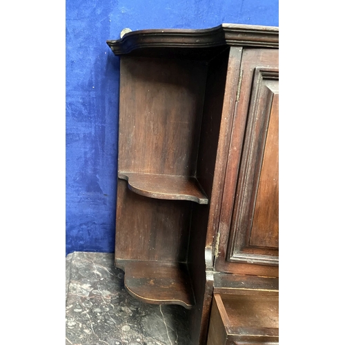 234 - AN ANTIQUE MAHOGANY HANGING CABINET, with shaped reeded border to top above two panelled doors over ... 