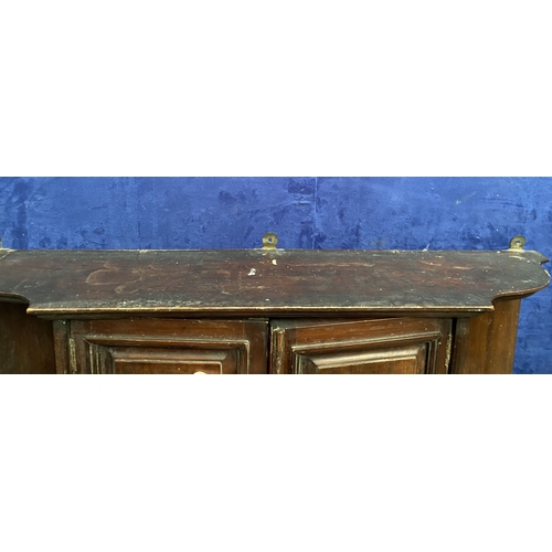 234 - AN ANTIQUE MAHOGANY HANGING CABINET, with shaped reeded border to top above two panelled doors over ... 
