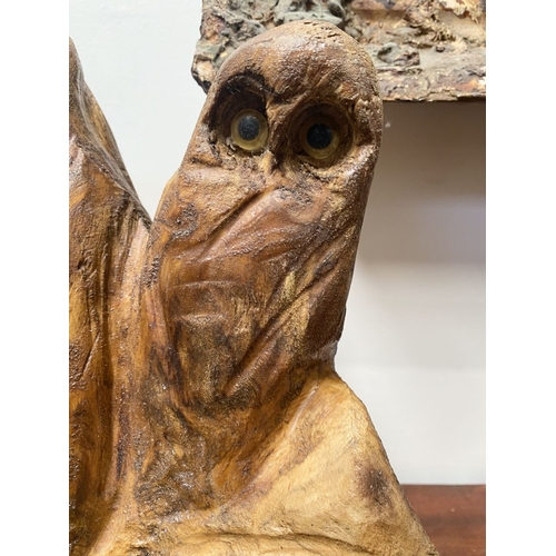 235 - A HARDWOOD CARVED OWL SCULPTURE, carved from one piece of wood, the owls with beaded eyes. On rectan... 