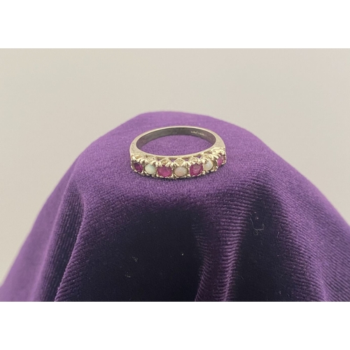 241 - A LOVELY SILVER OPAL & PINK GEMSTONE SEVEN STONE RING, with four round cut pink gemstones separated ... 