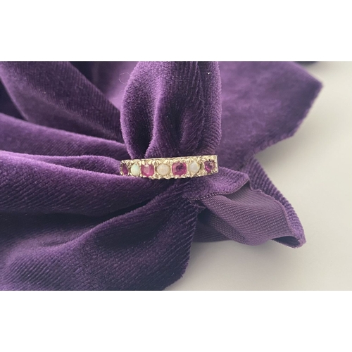 241 - A LOVELY SILVER OPAL & PINK GEMSTONE SEVEN STONE RING, with four round cut pink gemstones separated ... 