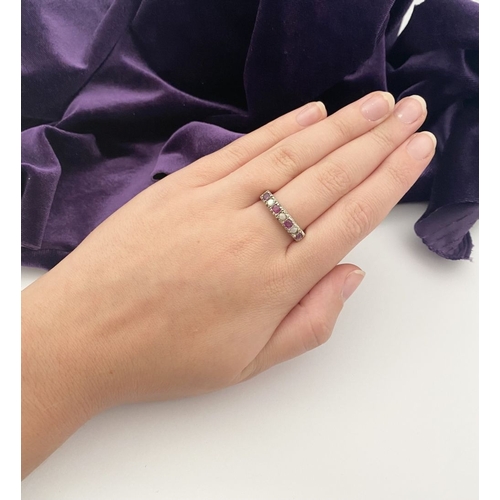 241 - A LOVELY SILVER OPAL & PINK GEMSTONE SEVEN STONE RING, with four round cut pink gemstones separated ... 