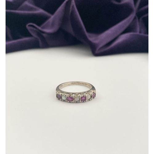 241 - A LOVELY SILVER OPAL & PINK GEMSTONE SEVEN STONE RING, with four round cut pink gemstones separated ... 