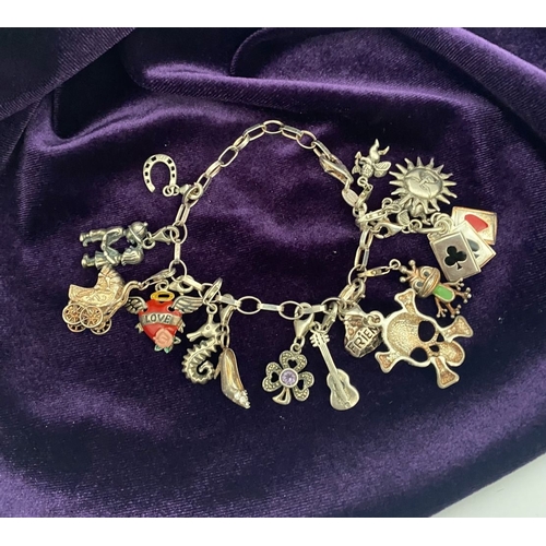 246 - A STERLING SILVER CHARM BRACELET, cable chain bracelet, hallmarked 925 to clasp, & 925 Italy, with 1... 