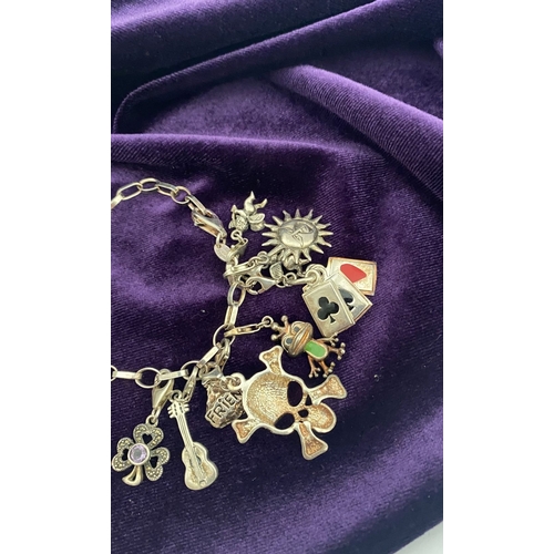 246 - A STERLING SILVER CHARM BRACELET, cable chain bracelet, hallmarked 925 to clasp, & 925 Italy, with 1... 