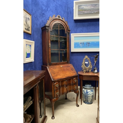 25 - A MAHOGANY QUEEN ANNE STYLE BUREAU BOOKCASE, the carved pediment to arched top with shell motif to c... 