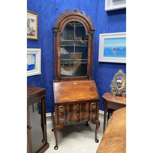 25 - A MAHOGANY QUEEN ANNE STYLE BUREAU BOOKCASE, the carved pediment to arched top with shell motif to c... 