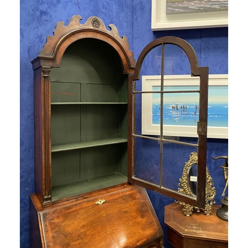 25 - A MAHOGANY QUEEN ANNE STYLE BUREAU BOOKCASE, the carved pediment to arched top with shell motif to c... 