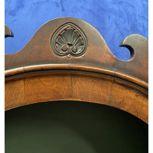 25 - A MAHOGANY QUEEN ANNE STYLE BUREAU BOOKCASE, the carved pediment to arched top with shell motif to c... 