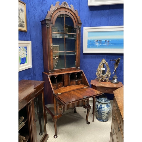 25 - A MAHOGANY QUEEN ANNE STYLE BUREAU BOOKCASE, the carved pediment to arched top with shell motif to c... 