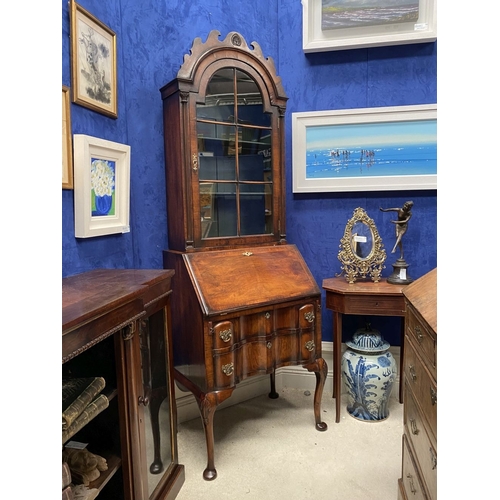 25 - A MAHOGANY QUEEN ANNE STYLE BUREAU BOOKCASE, the carved pediment to arched top with shell motif to c... 
