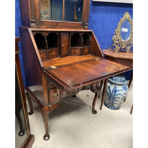 25 - A MAHOGANY QUEEN ANNE STYLE BUREAU BOOKCASE, the carved pediment to arched top with shell motif to c... 