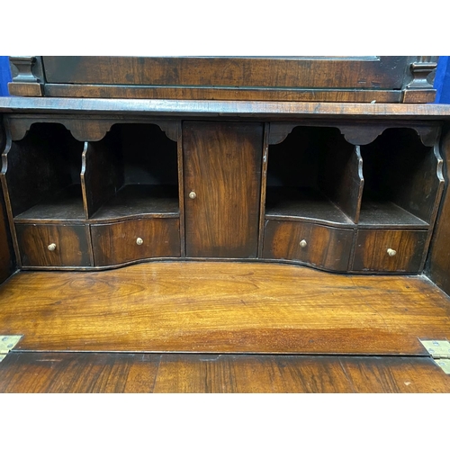 25 - A MAHOGANY QUEEN ANNE STYLE BUREAU BOOKCASE, the carved pediment to arched top with shell motif to c... 