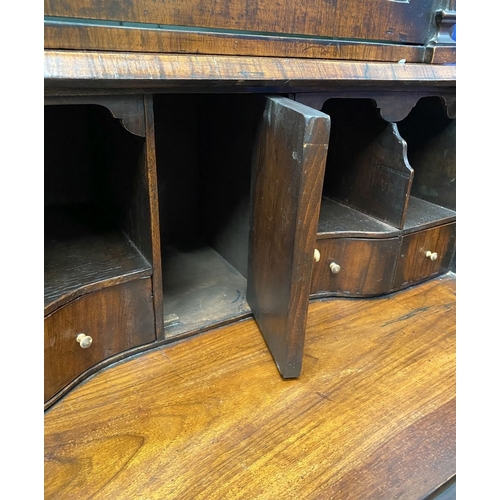 25 - A MAHOGANY QUEEN ANNE STYLE BUREAU BOOKCASE, the carved pediment to arched top with shell motif to c... 