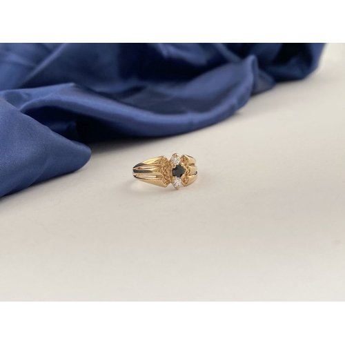 254 - A PRETTY IRISH 9CT GOLD THREE STONE RING, central round cut blue gemstone with two round cut clear g... 