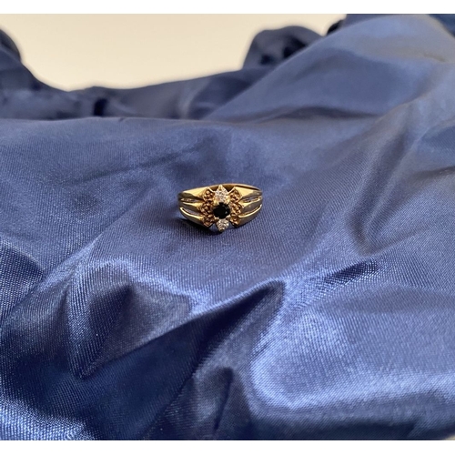 254 - A PRETTY IRISH 9CT GOLD THREE STONE RING, central round cut blue gemstone with two round cut clear g... 