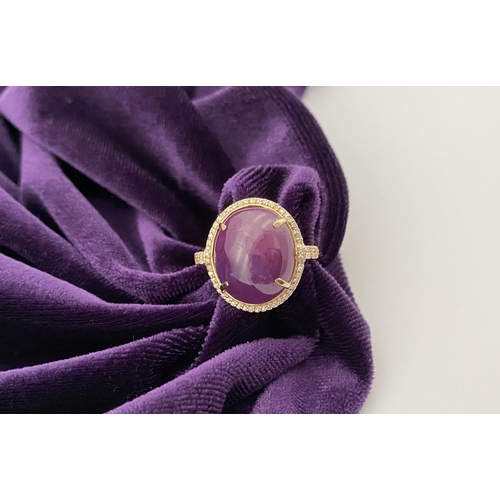 35 - A STRIKING 14CT YELLOW GOLD OVAL CABOCHON RUBY & DIAMOND CLUSTER RING, with central oval cabochon cu... 