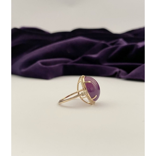 35 - A STRIKING 14CT YELLOW GOLD OVAL CABOCHON RUBY & DIAMOND CLUSTER RING, with central oval cabochon cu... 