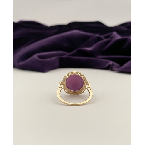 35 - A STRIKING 14CT YELLOW GOLD OVAL CABOCHON RUBY & DIAMOND CLUSTER RING, with central oval cabochon cu... 