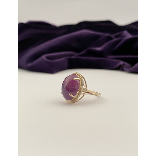 35 - A STRIKING 14CT YELLOW GOLD OVAL CABOCHON RUBY & DIAMOND CLUSTER RING, with central oval cabochon cu... 