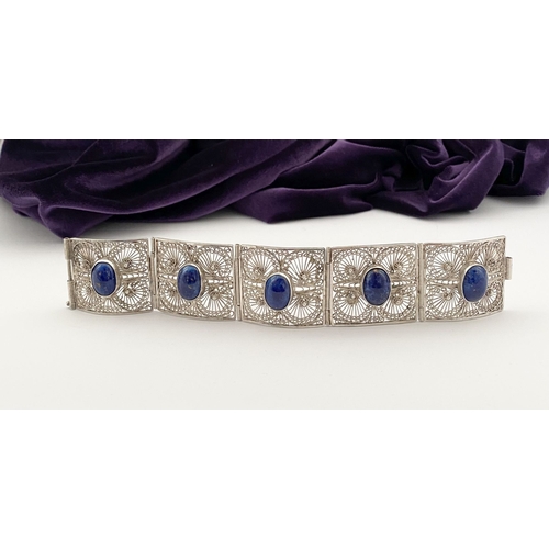 47 - A VICTORIAN FILIGREE SILVER BRACELET WITH LAPIS LAZULI CABOCHONS, with five oval lapis lazuli caboch... 