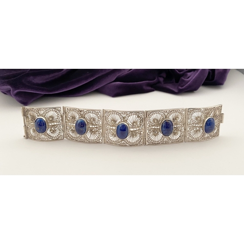 47 - A VICTORIAN FILIGREE SILVER BRACELET WITH LAPIS LAZULI CABOCHONS, with five oval lapis lazuli caboch... 
