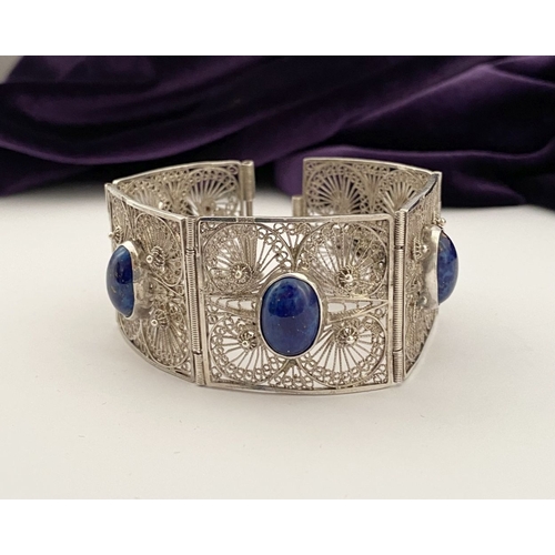 47 - A VICTORIAN FILIGREE SILVER BRACELET WITH LAPIS LAZULI CABOCHONS, with five oval lapis lazuli caboch... 