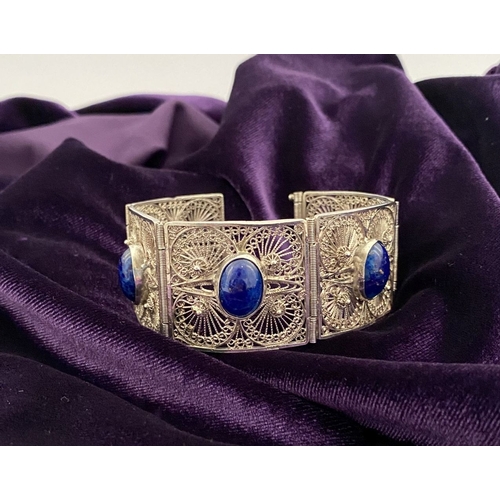47 - A VICTORIAN FILIGREE SILVER BRACELET WITH LAPIS LAZULI CABOCHONS, with five oval lapis lazuli caboch... 