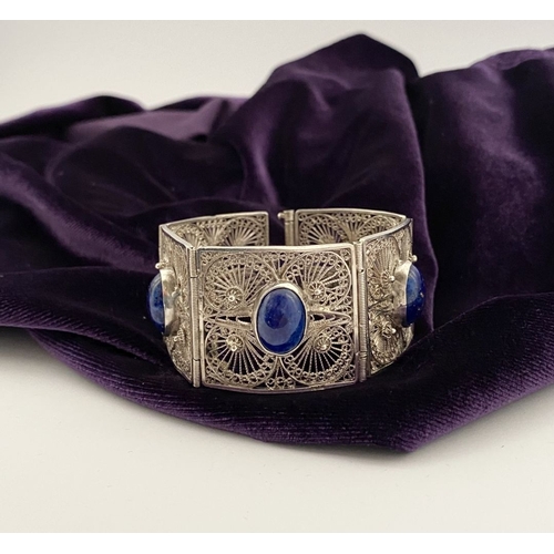 47 - A VICTORIAN FILIGREE SILVER BRACELET WITH LAPIS LAZULI CABOCHONS, with five oval lapis lazuli caboch... 