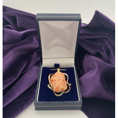 48 - A BEAUTIFUL 9CT GOLD ORANGE CORAL PENDANT NECKLACE WITH DIAMONDS, finely carved orange coral bust ho... 