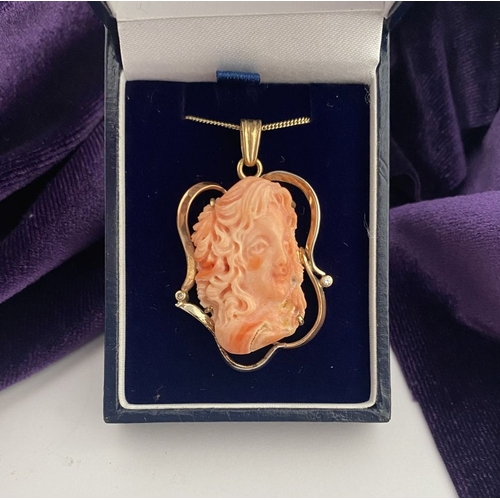 48 - A BEAUTIFUL 9CT GOLD ORANGE CORAL PENDANT NECKLACE WITH DIAMONDS, finely carved orange coral bust ho... 
