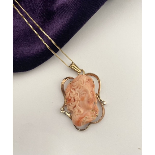 48 - A BEAUTIFUL 9CT GOLD ORANGE CORAL PENDANT NECKLACE WITH DIAMONDS, finely carved orange coral bust ho... 