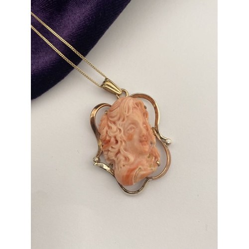 48 - A BEAUTIFUL 9CT GOLD ORANGE CORAL PENDANT NECKLACE WITH DIAMONDS, finely carved orange coral bust ho... 