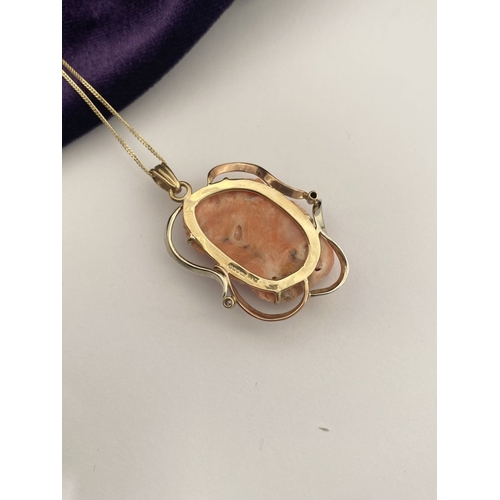 48 - A BEAUTIFUL 9CT GOLD ORANGE CORAL PENDANT NECKLACE WITH DIAMONDS, finely carved orange coral bust ho... 