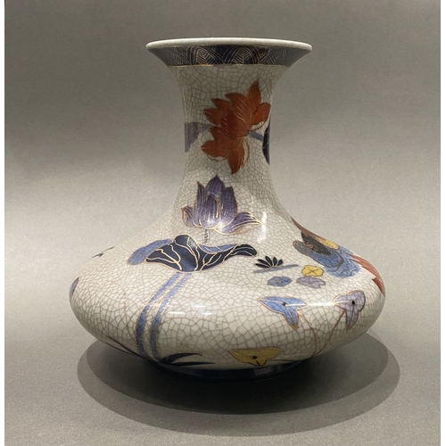 49 - AN ANTIQUE CHINESE CRACKLE GLAZED VASE, with flared rim, long concave neck and bulbous body, raised ... 