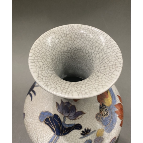 49 - AN ANTIQUE CHINESE CRACKLE GLAZED VASE, with flared rim, long concave neck and bulbous body, raised ... 