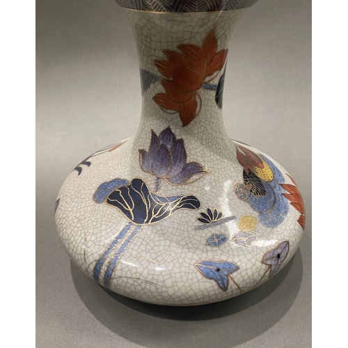 49 - AN ANTIQUE CHINESE CRACKLE GLAZED VASE, with flared rim, long concave neck and bulbous body, raised ... 