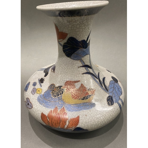 49 - AN ANTIQUE CHINESE CRACKLE GLAZED VASE, with flared rim, long concave neck and bulbous body, raised ... 