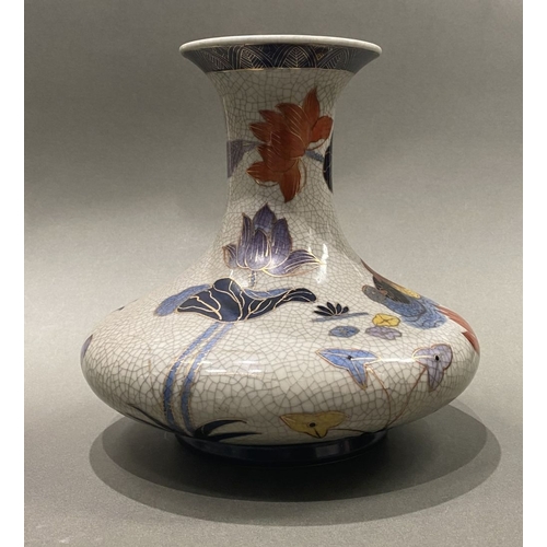 49 - AN ANTIQUE CHINESE CRACKLE GLAZED VASE, with flared rim, long concave neck and bulbous body, raised ... 