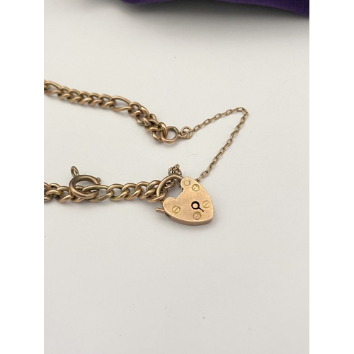 157 - A 9CT GOLD HEART LOCK PENDANT BRACELET, Figaro chain link bracelet, with heart lock pendant hallmark... 